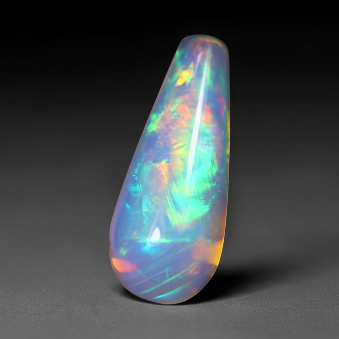 *3.85Ct Teardrop Welo Opal - Ethiopian Opal, 375C: Ksmith Heritage Auctioneers Subject: Natural Ethiopian Welo Opal Origin: Ethiopia Carat Weight: 3.85Ct Dimension: 17.6x7.3x7.3 mm Treatment: Natural Untreated Type: Cabochon, P