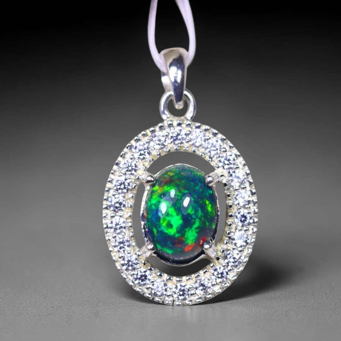 Silver Pendant with Ethiopian Black Opal 3.5grams - 925 Sterling Silver , 987E: Ksmith Heritage Auctioneers Subject: Opal & Simulated Diamond Silver Pendant Carat Weight: 3.5 grams (approx.) Dimension: Opal 10x7mm, Pendant 22x15mm