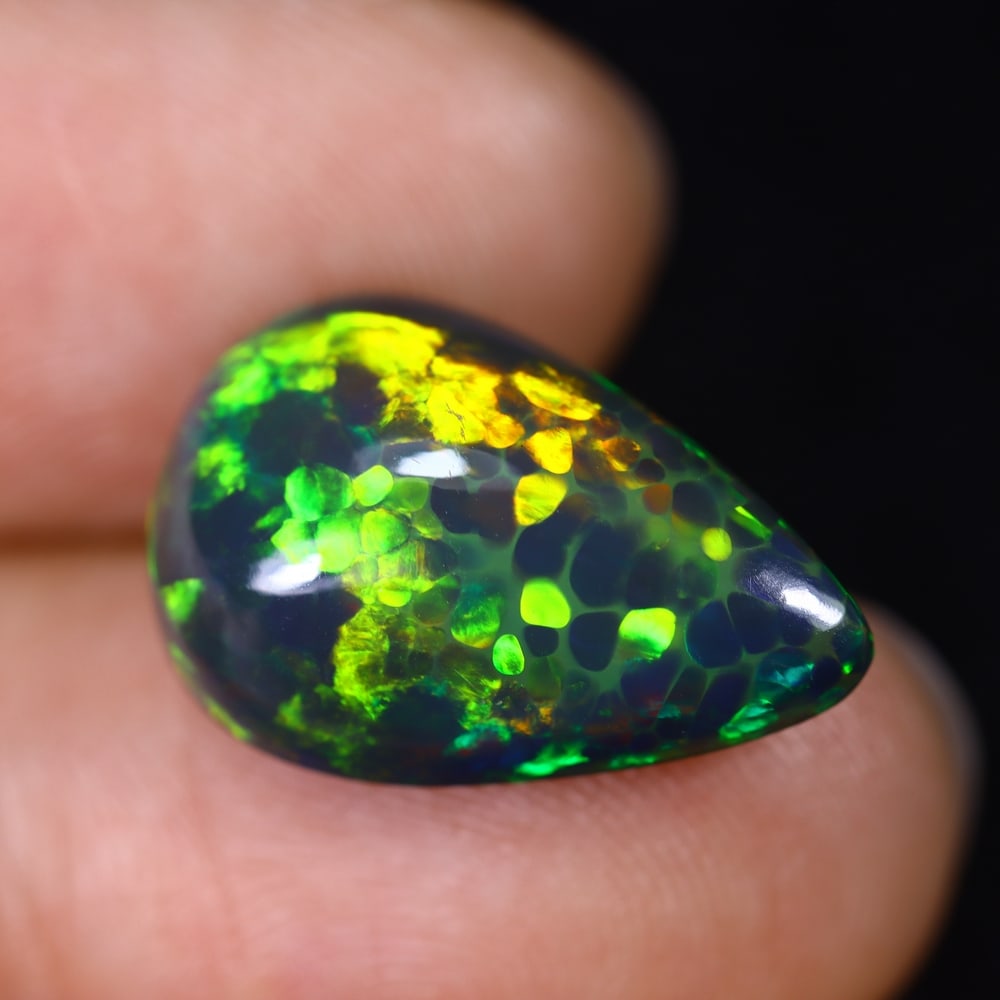 6.69Ct Natural Ethiopian Black Opal - 18.0x11.8x7.5 mm , 592C: Ksmith Heritage Auctioneers Subject: Natural Ethiopian Welo Opal Origin: Ethiopia Treatment: Smoked