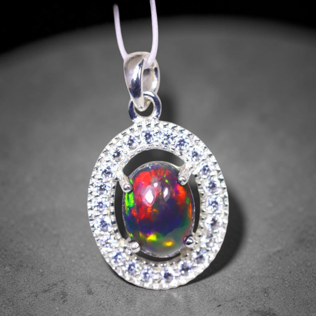 Silver Pendant with Ethiopian Black Opal 3.5grams - 925 Sterling Silver, 89B: Ksmith Heritage Auctioneers Subject: Opal & Simulated Diamond Silver Pendant Carat Weight: 3.5 grams (approx.) Dimension: Opal 10x7mm, Pendant 22x15mm