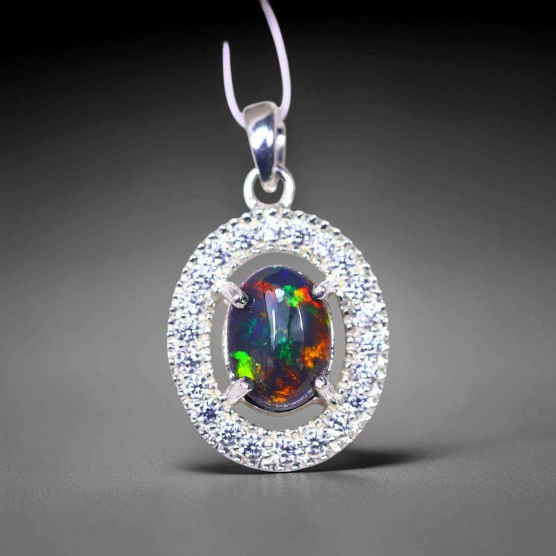 Silver Pendant with Ethiopian Black Opal 3.5grams - 925 Sterling Silver , 409E: Ksmith Heritage Auctioneers Subject: Opal & Simulated Diamond Silver Pendant Carat Weight: 3.5 grams (approx.) Dimension: Opal 10x7mm, Pendant 22x15mm