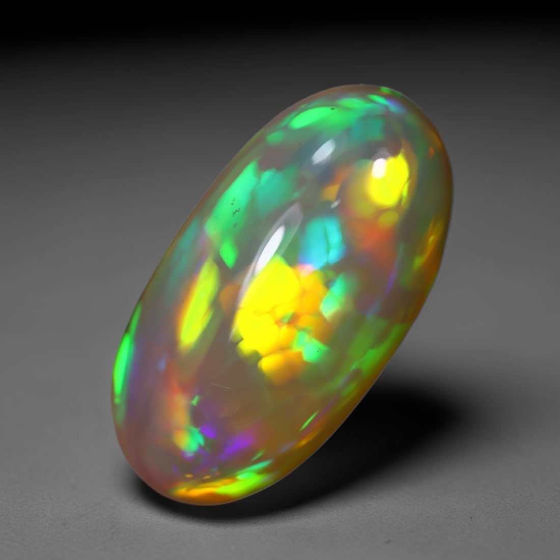 *7.43Ct Welo Opal Polished - Ethiopian Opal , 426C: Ksmith Heritage Auctioneers Subject: Natural Ethiopian Welo Opal Origin: Ethiopia Carat Weight: 6.52Ct Dimension: 18.1x14.3x4.7 mm Treatment: Natural Untreated Type: Caboc