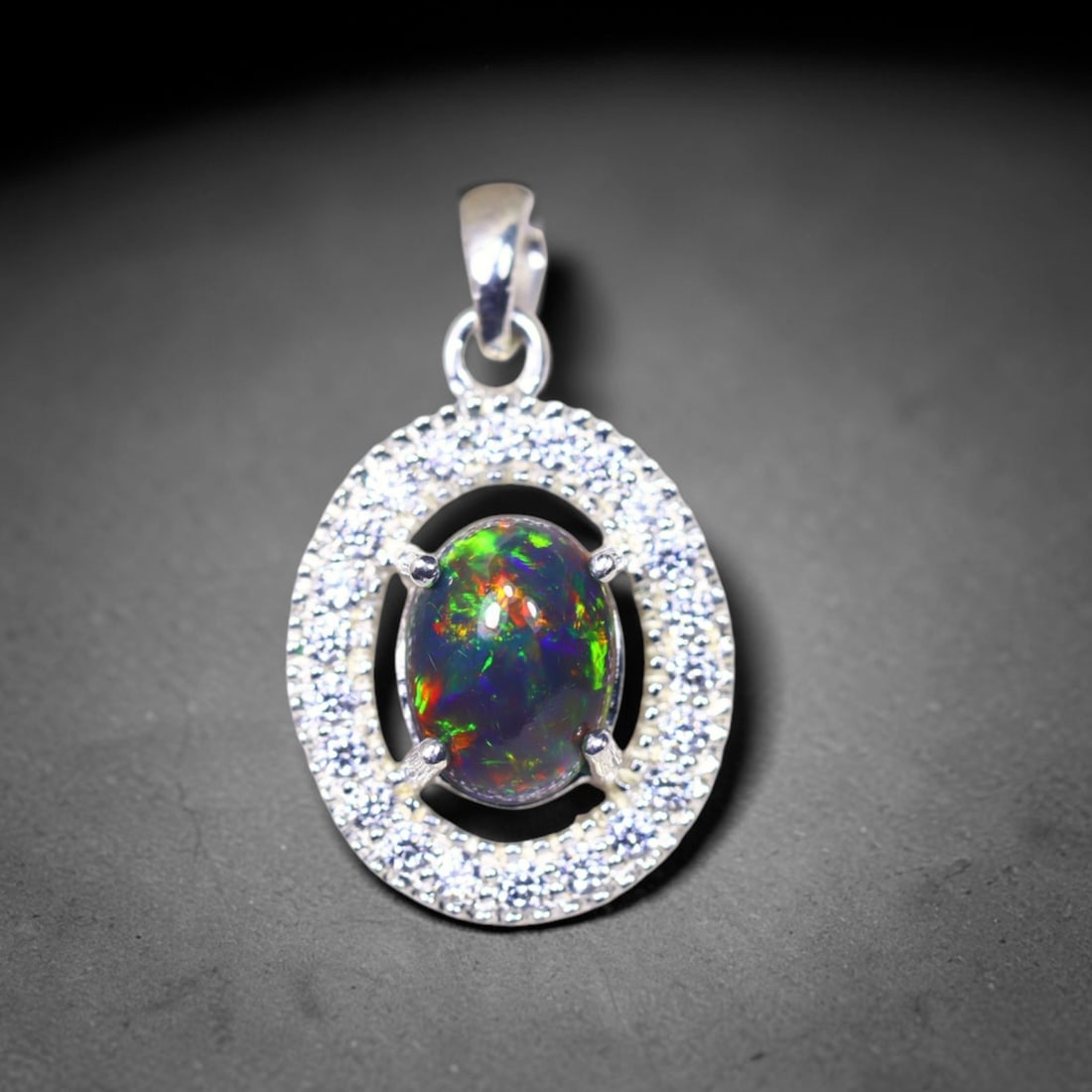 Silver Pendant with Ethiopian Black Opal 3.5grams - 925 Sterling Silver, 757B: Ksmith Heritage Auctioneers Subject: Opal & Simulated Diamond Silver Pendant Carat Weight: 3.5 grams (approx.) Dimension: Opal 10x7mm, Pendant 22x15mm