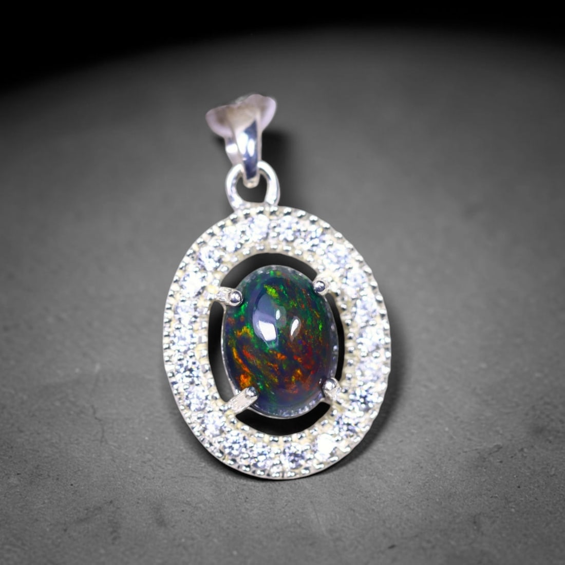 Silver Pendant with Ethiopian Black Opal 3.5grams - 925 Sterling Silver, 408B: Ksmith Heritage Auctioneers Subject: Opal & Simulated Diamond Silver Pendant Carat Weight: 3.5 grams (approx.) Dimension: Opal 10x7mm, Pendant 22x15mm