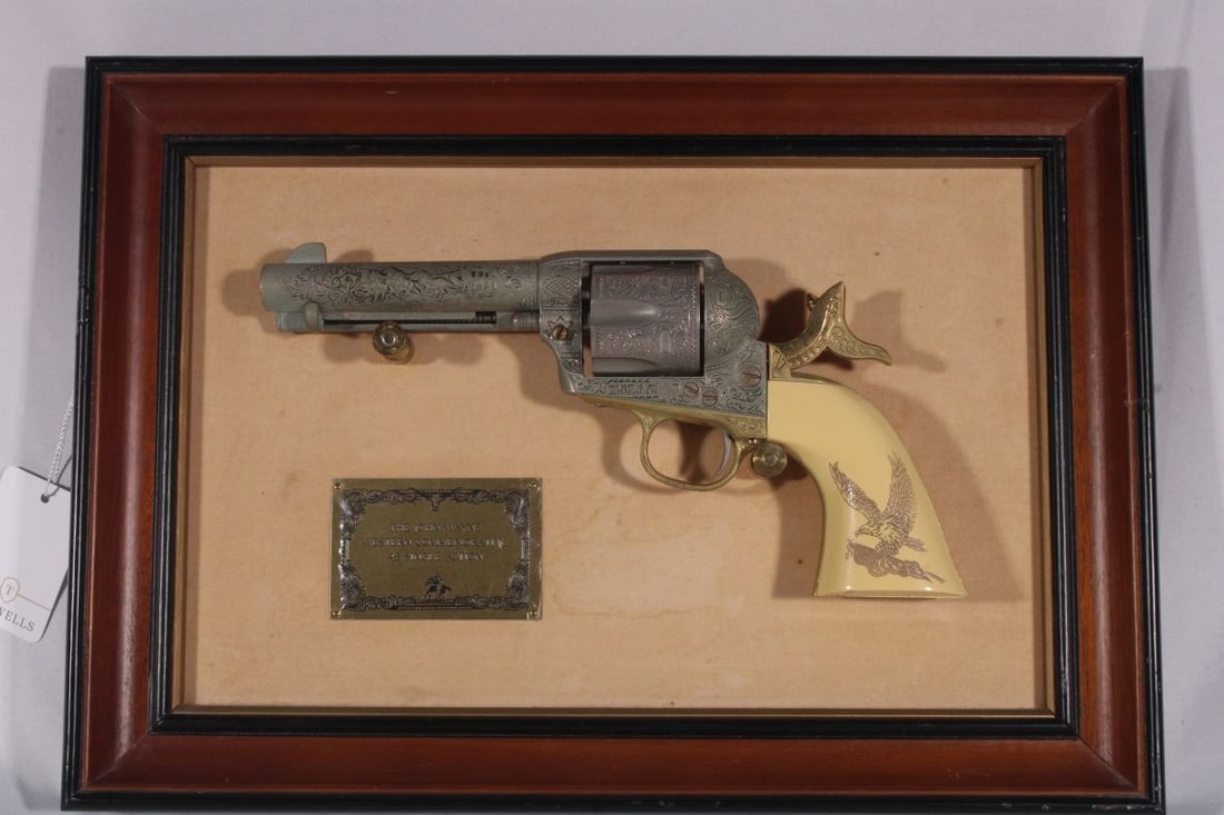 Commemorative .45 Caliber Single Action Baroque Design Engraved Revolver with Eagle Carved on Pearl: The box that holds revolver measures 15.75 inches in length and 11 inches in width. The provenance of this item is from a Queens collector.