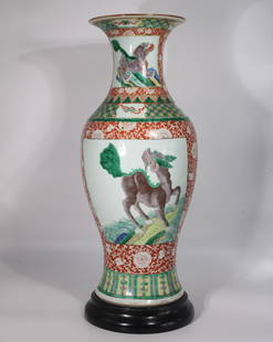 A Large Chinese Wu Cai Vase wit a Wooden Base, Qing Dynasty: A beautiful Wu Cai vase with Kirin painted on. Height: 22.5 inches Width: 9.5 inches