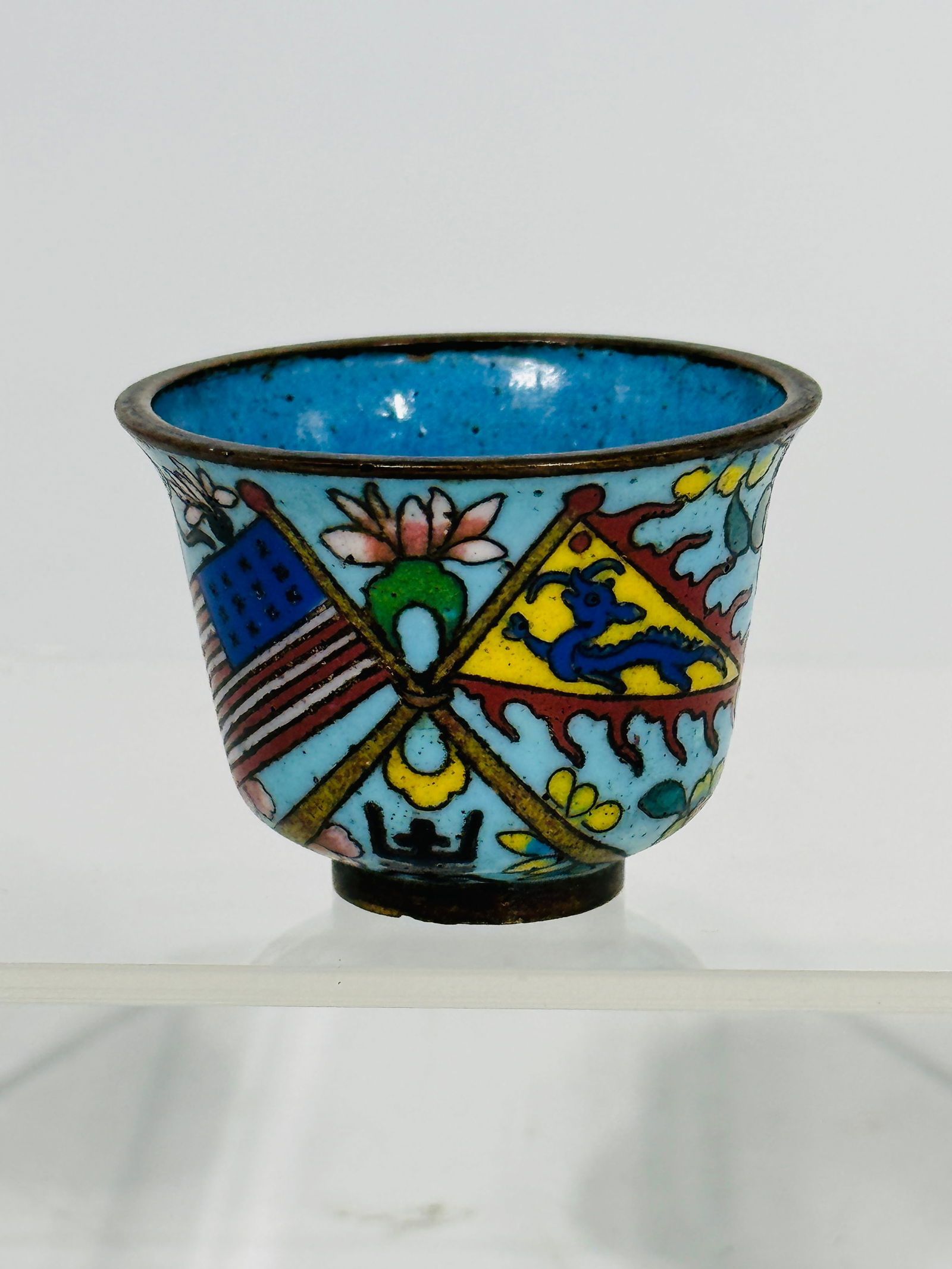 A Great White Fleet Cloisonne Cup: The height is 1.3 inches and the diameter is 1.8 inches.