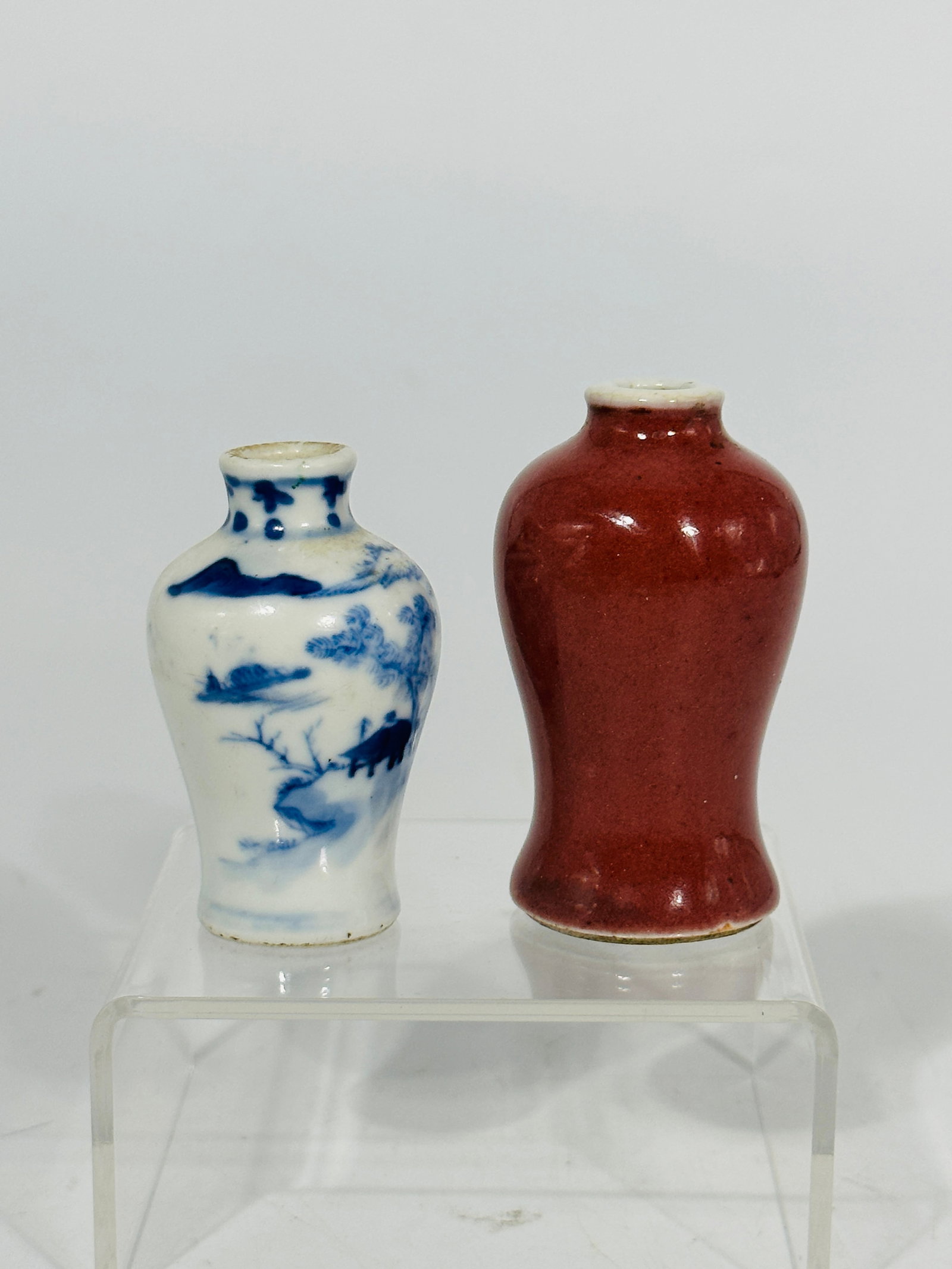 Chinese Blue and White Porcelain Snuff Botlle and Chinese Red-Glaze Snuff Bottle: The Red-glaze Snuff Botlle has a height of 2.75 inches and a width of 1.5 inches. The Blue and White Snuff Botlle has a height of 2.4 inches and a width of 1.4 inches.