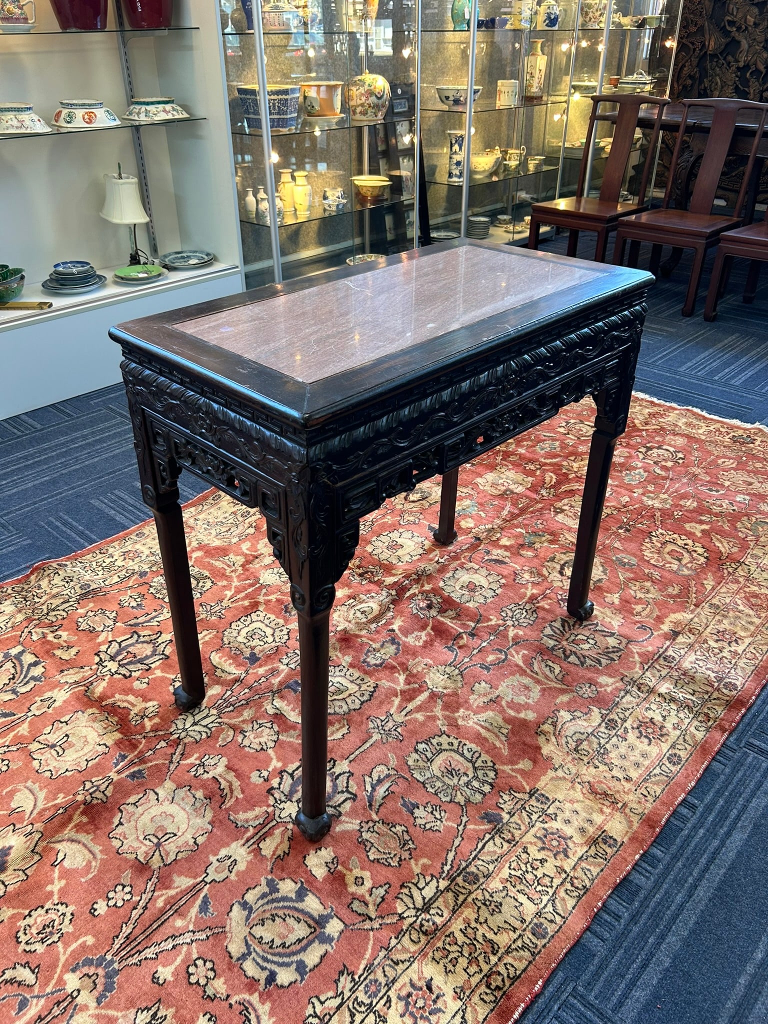 A Marble-Inset Corner-Leg Table: 32 in. (81.3 cm.) high, 34.1/2 in. (87 cm.) wide, 18.3/4 in. (47.6 cm.) deep.