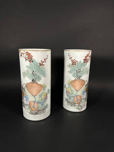 A Pair of Famille Rose 'Antique and Flower' Hat Stands, Republic Period: Depicting Chinese antiques and flowers, inscribed and signed by Jia Xingqing, 11.1 in. high, 4.9 in. wide each.