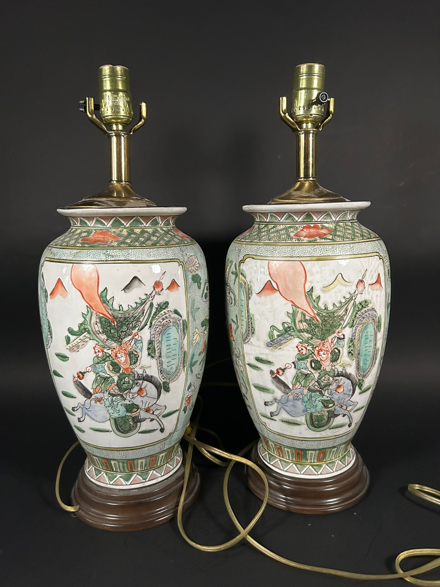 A Pair of Famille Verte 'Medallion' 'Warriors' Vases, Qing Dynasty: Mounted as Lamps, 18.1/2 in. (47 cm.) high, 6.1/2 in. (16.5 cm.) wide each overall.