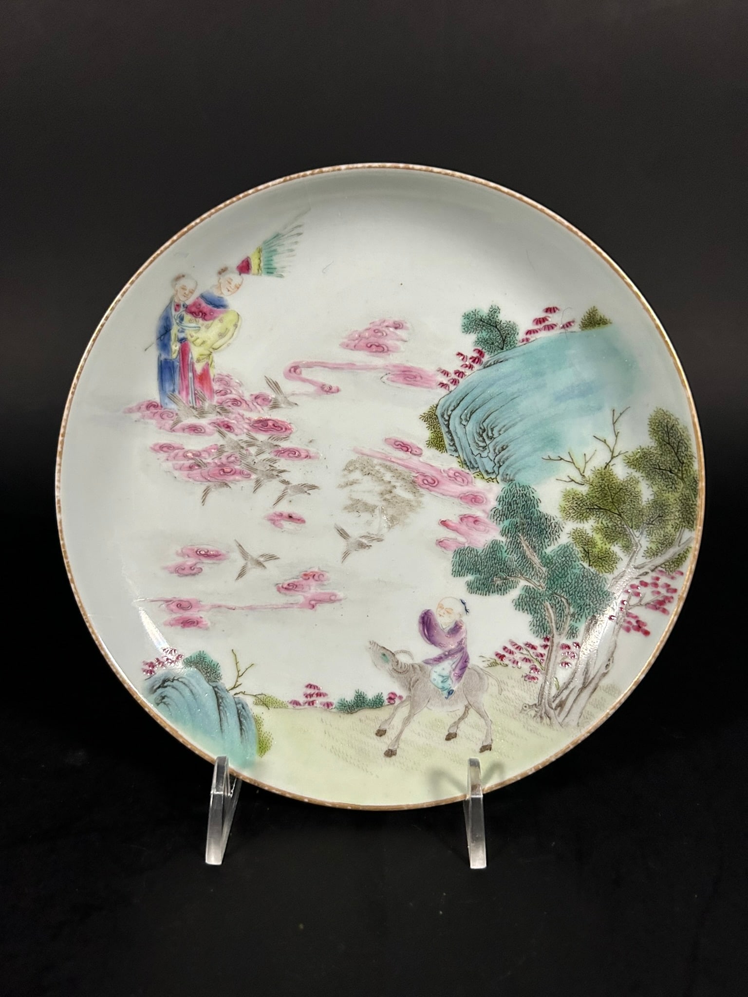 A Chinese Famille Rose 'Zhinv the Spinning Maid and Niulang the Herdboy' Dish, Guagnxu Six-Character: Beautifully depicting the scene of the cowherd and the weaver girl meeting each other. 6.1/2 in. (16.5 cm.) diam.