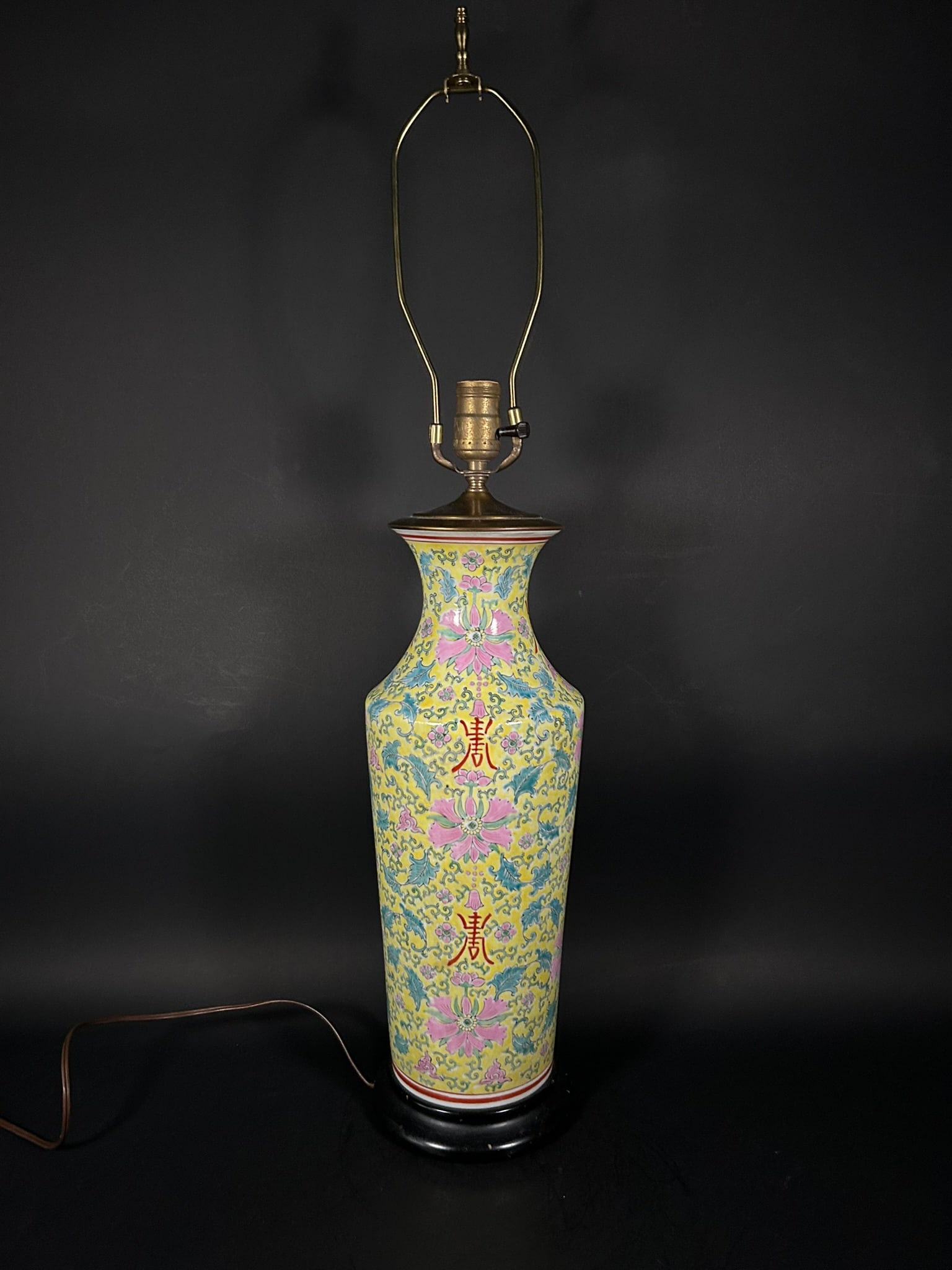 A Chinese Famille Rose Yellow-Ground 'Shou' Vase, Late Qing Dynasty/Republic Period: Mounted as a lamp, 32 in. (81.3 cm.) high over all, 6.3/8 in. (16.2 cm.) wide.