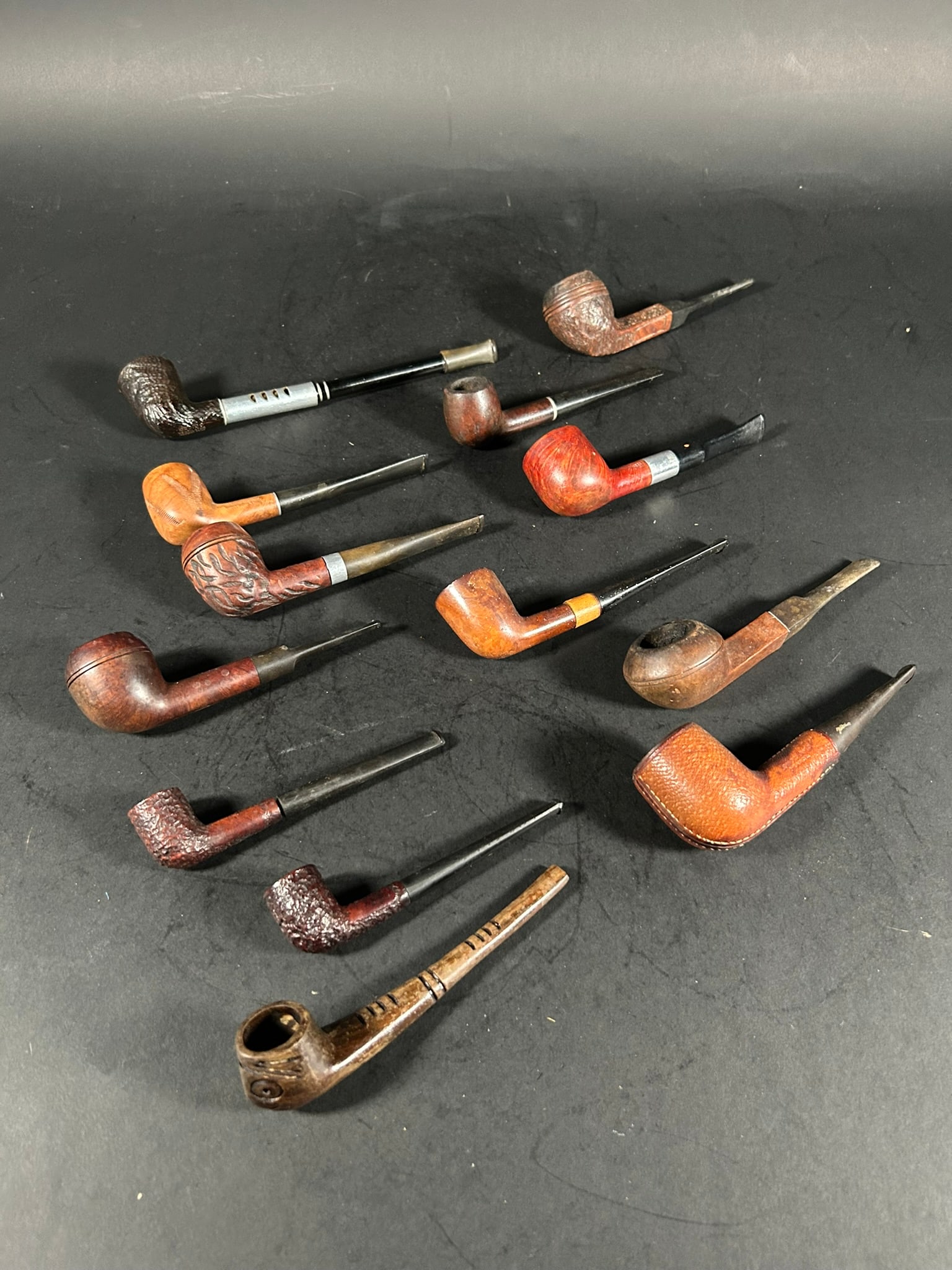 A Group of Thirteen Smoking Pipes: Comprising smoking pipes made by Royal Duke Dr. Grabow, Longchamp France, Lowell, Mirejovsky, Medico, etc., with the largest one measures 8.1/4 in. (21 cm.) long, and the smallest one measures 4.5/8 i