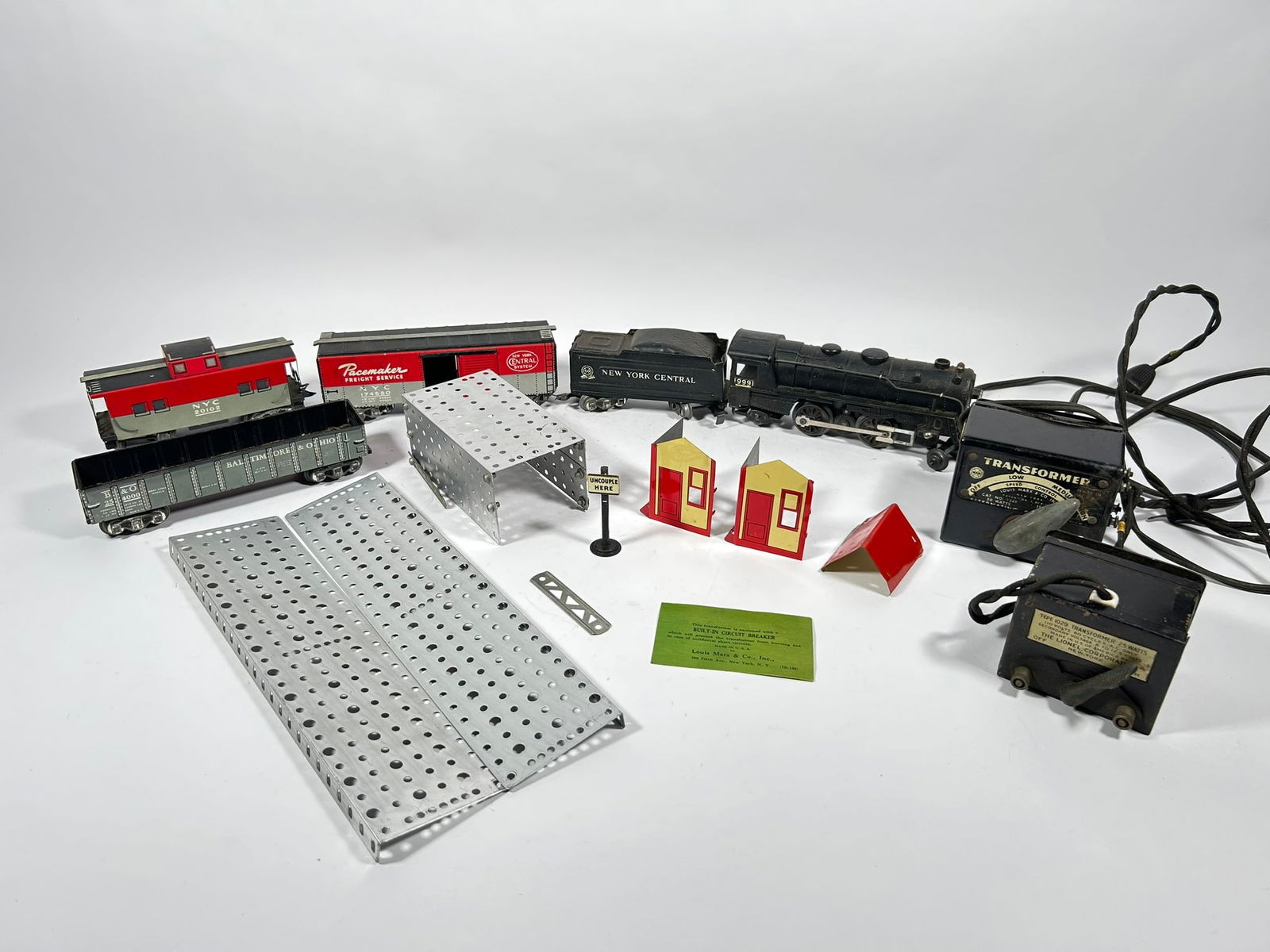 A Set of Vintage Marx Toy Train Set (Part): Comprising toy parts of MARX Lionel Engine, New York Central Tender, Freight Car, Caboose, and transformers. The MARX Lionel Engine measures 8.1/2 in. long.