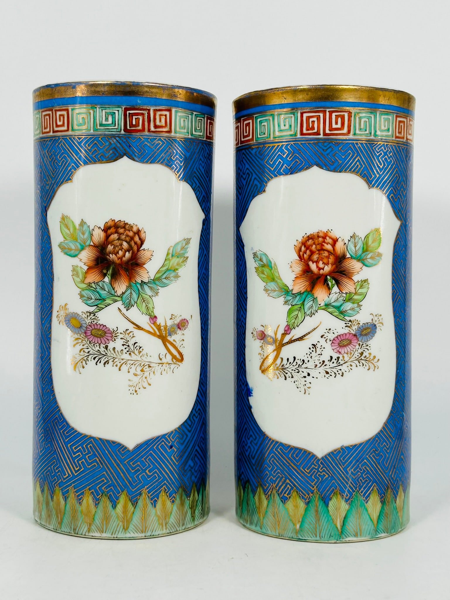 A Pair of Chinese Famille Rose 'Medallion' Blue-Ground Hat Stands: 11.3 in. high, 4.2 in. diam.