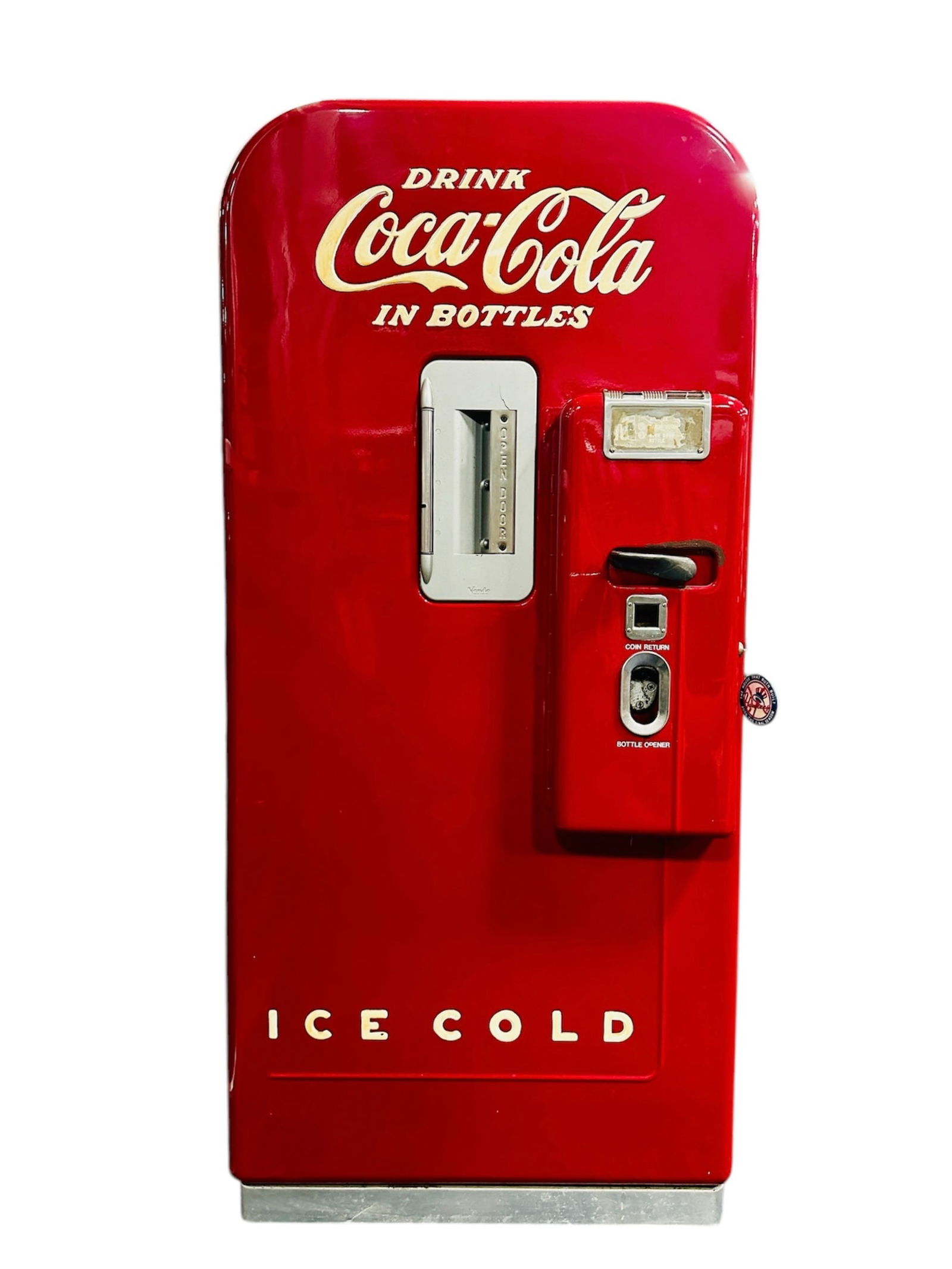 A Vintage COCA-COLA Vending Machine, Vendo-39, c. 1955: This 5-cent vending machine features a classic uniform red design. It has a bottle capacity of 39 and a pre-cool capacity of 20. The refrigeration system is a 1/8 h.p. sealed unit. This item comes wit