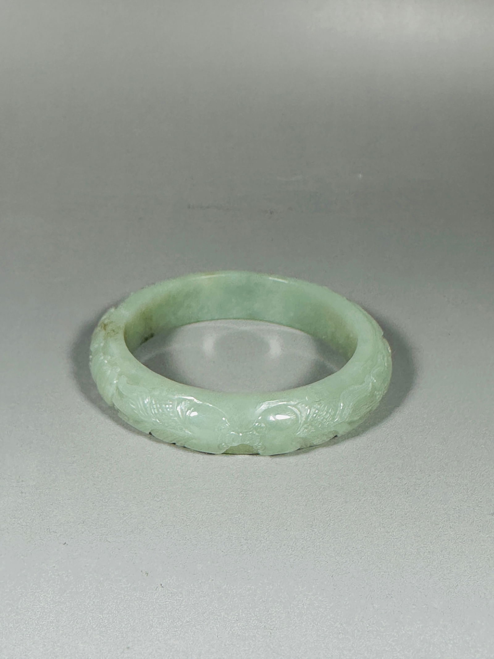 A Chinese Pale Celadon Carved Jade 'Phoenix' Bangle (1 of 5)