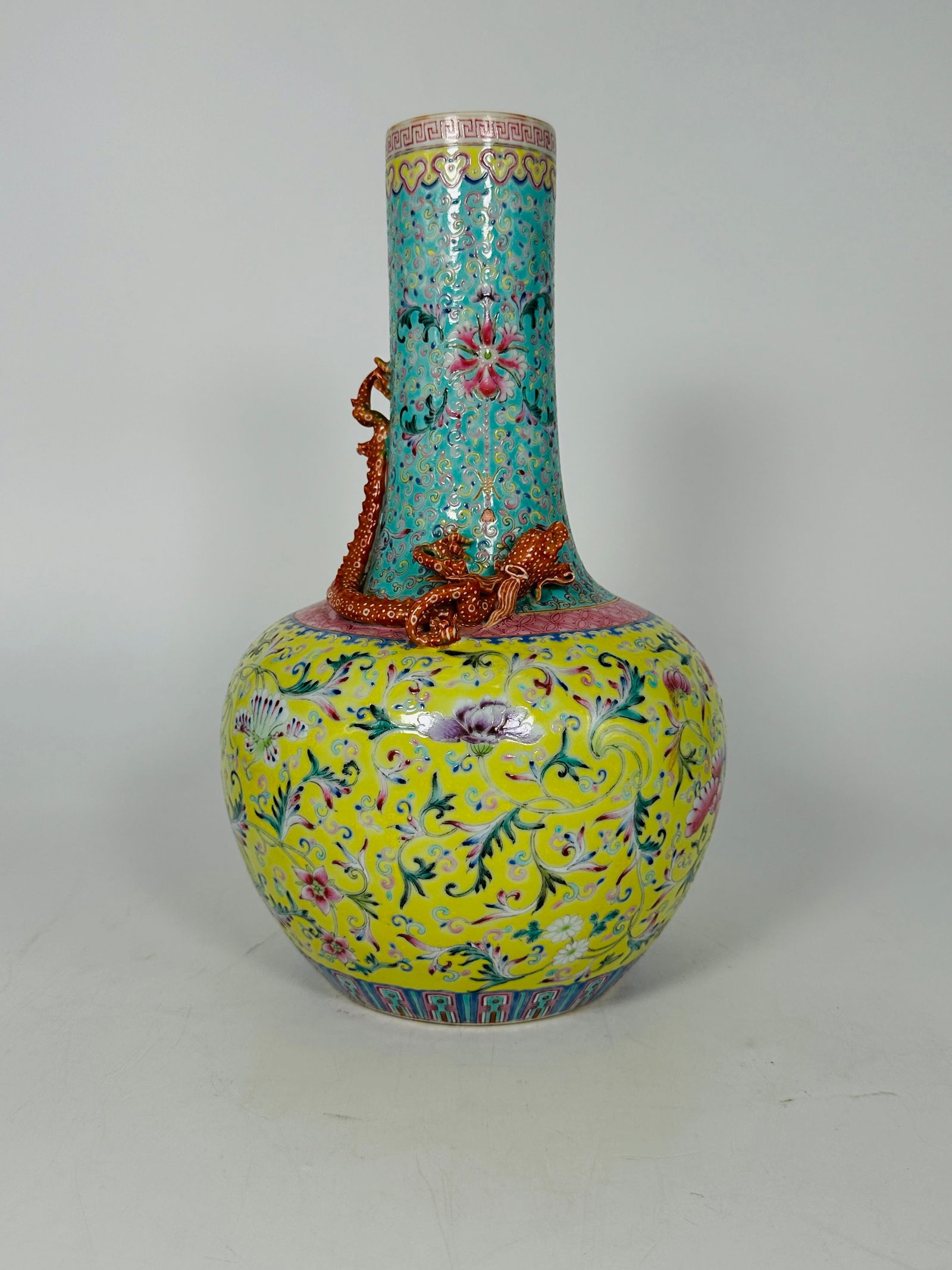 A Chinese Famille Rose Turquoise and Yellow Ground Vase with Dragon Relief, Late Qing Dynasty: 11 3/4 in. high, 7 in. wide.