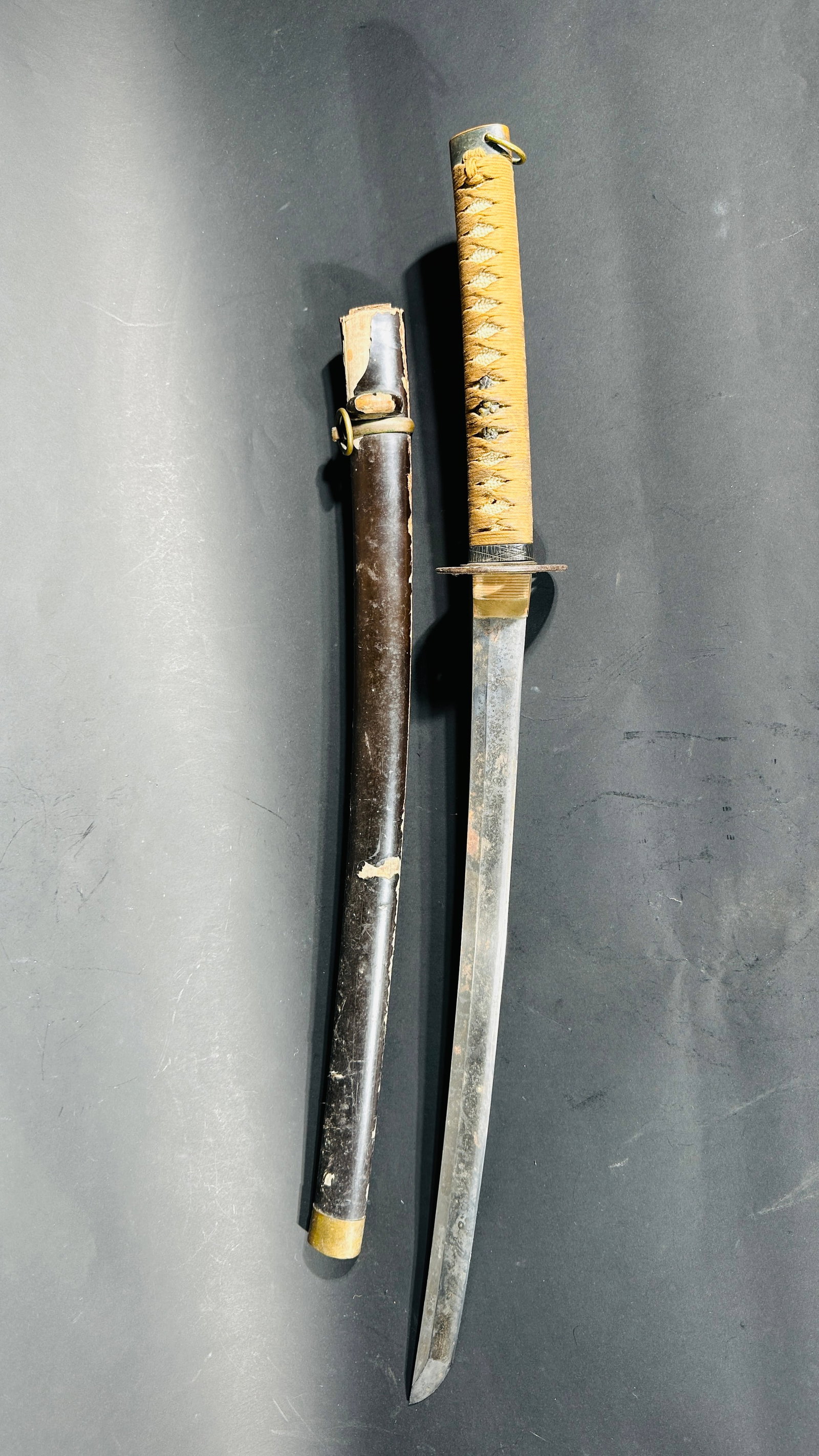 A Japanese Samurai Sword Wakizashi: Black lacquer scabbard. Unable to remove tsuka. 21.3/4 in. long for the blade, 33.3/4 in. long overall.