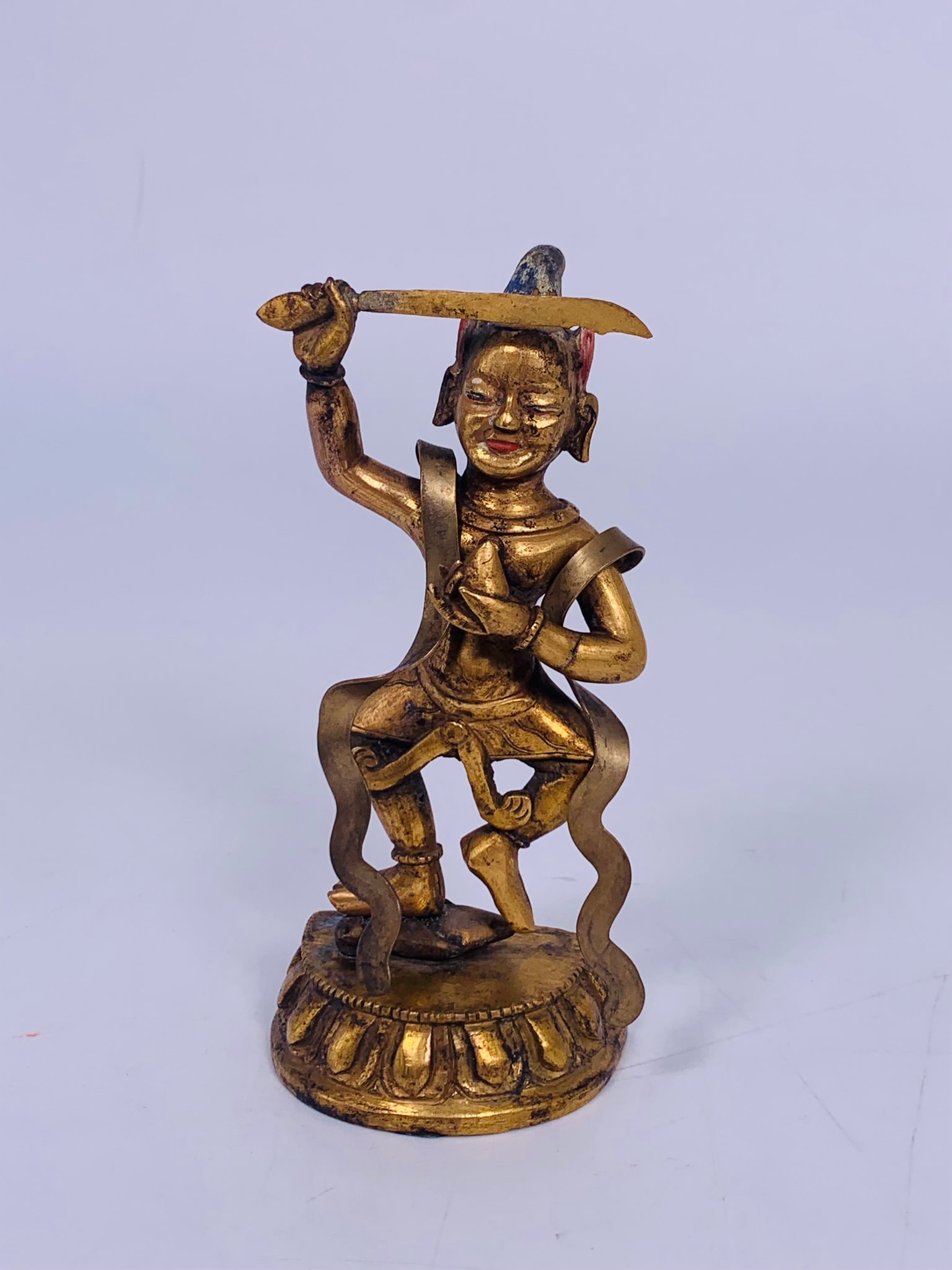 A Tibetan Painted Gilt-Bronze Figure of Manjushri: 5.1/8 in. high, 2.5/8 in. wide.