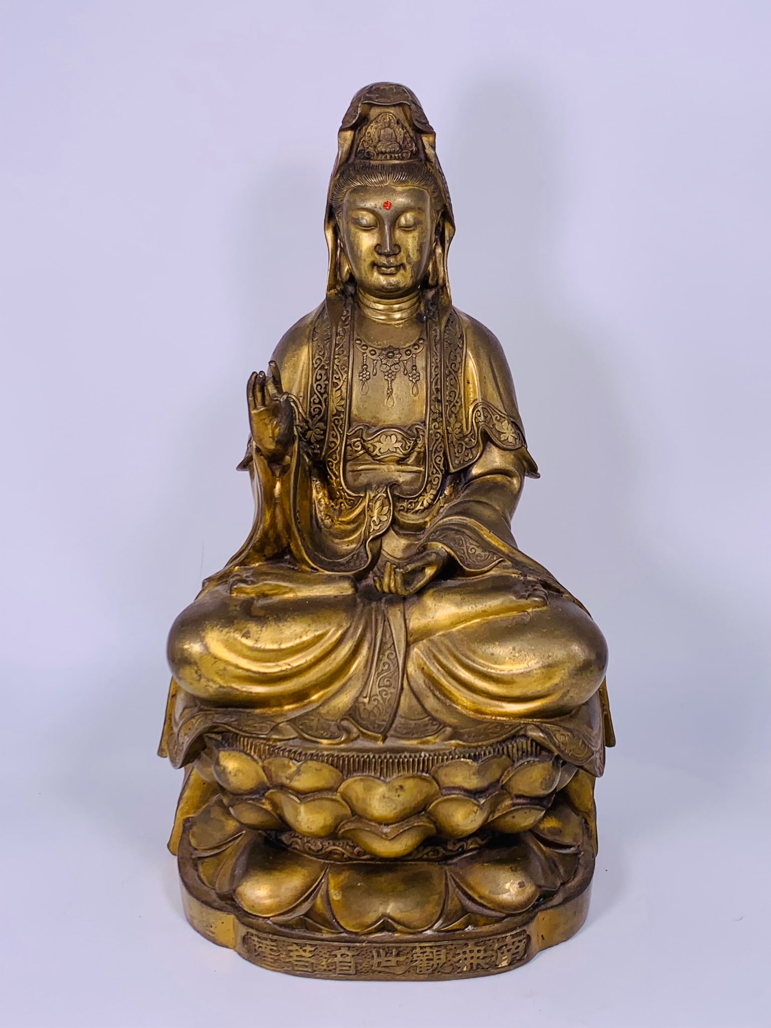 A Chinese Gilt-Bronze Figure of Seated Guanyin: 17.3/4 in. high, 9.1/2 in. wide.