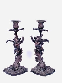 A Pair of Antique Bronze Cherub Candleholders