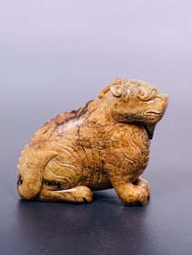A Carved Stone Figure of a Lion