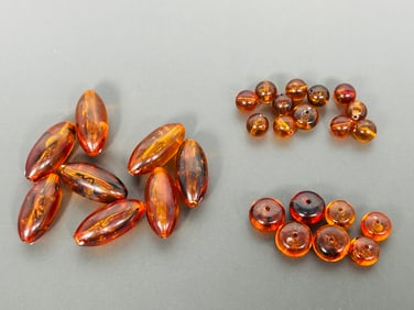 A Group of Fifteen Amber Beads