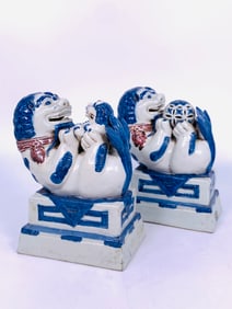 A Pair of Blue and Red Painted Pottery Figures of Buddhist Lions