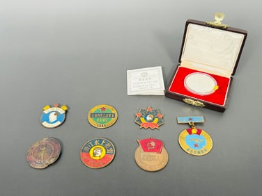 A Group of Seven Chinese PLA Meritorious Service Medals and One Commemorative Coin