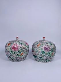 A Pair of Chinese Famille Rose Mille Fleurs Jars and Covers