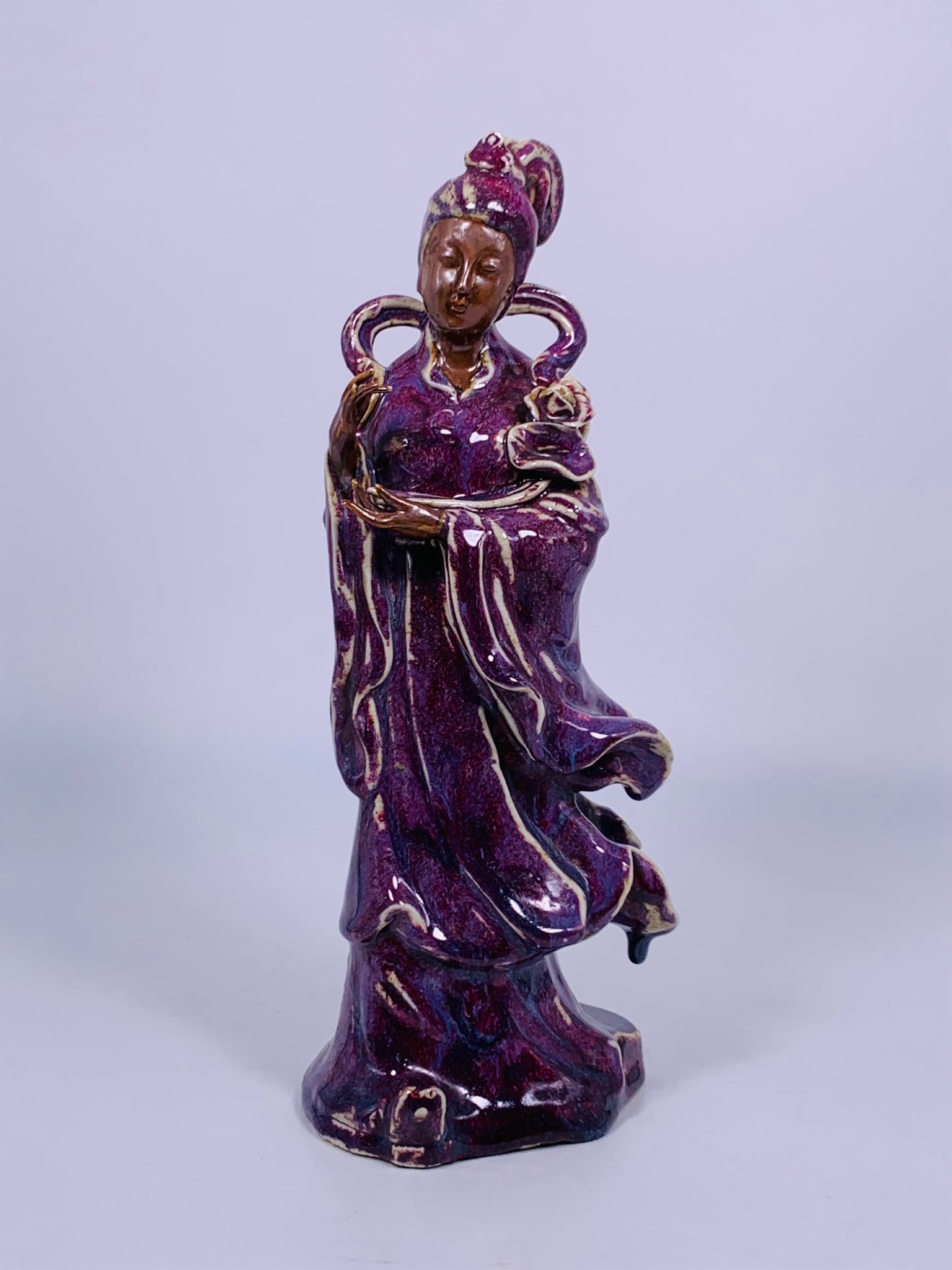 A Chinese Flambe-Glazed Figure of Guanyin, Qing Dynasty: 14.25 in. high, 5.75 in. wide.