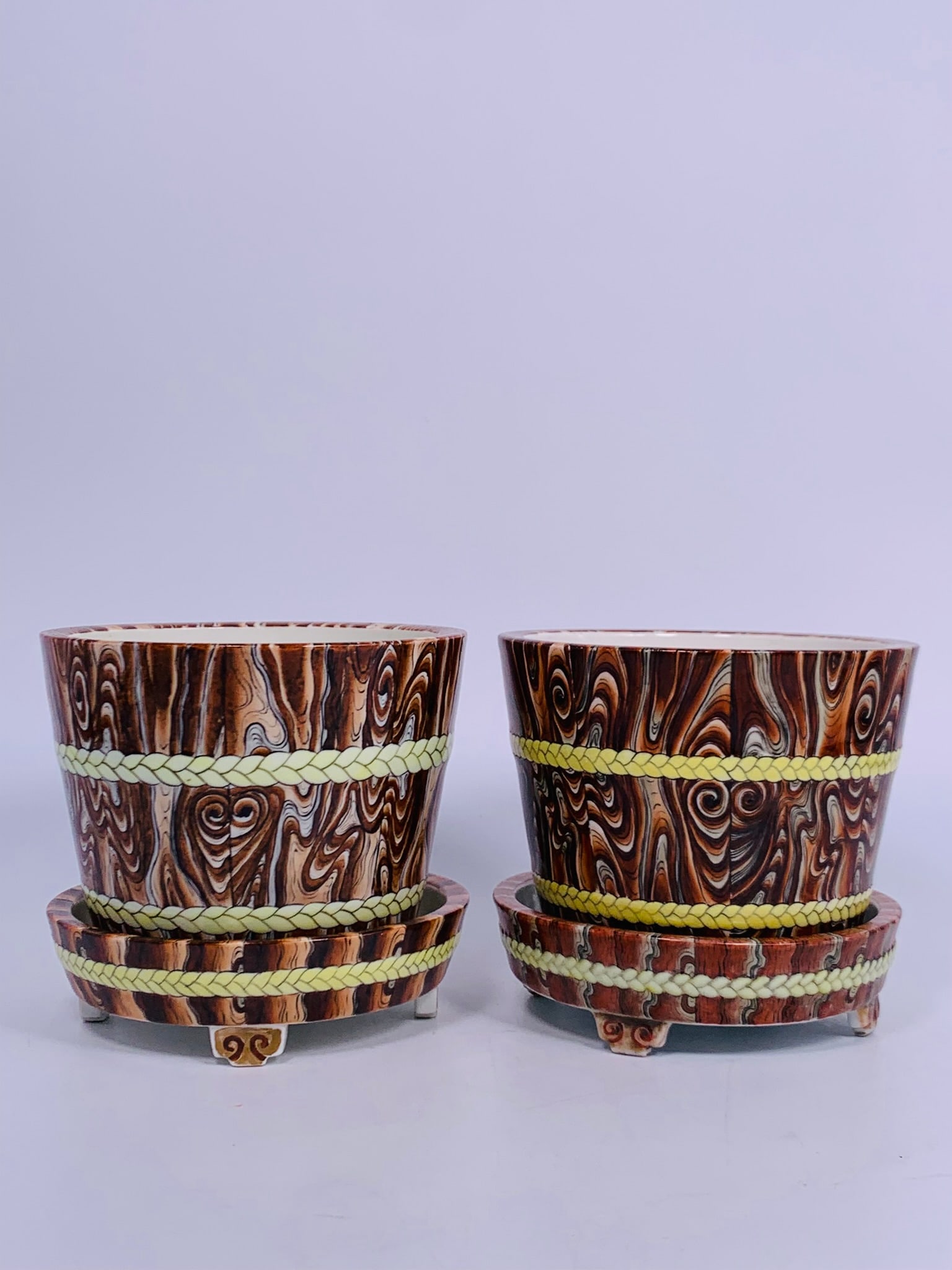 A Pair of Chinese Famille Rose Faux Bois Jardinieres and Stands: 5.25 in. high, 5.75 in. wide each.