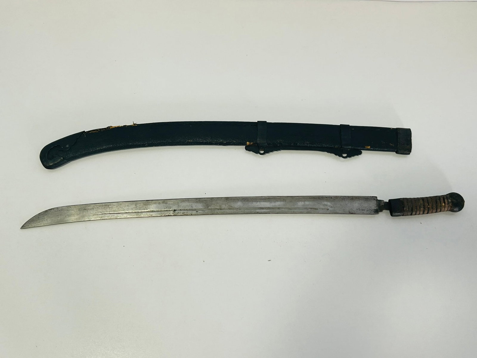 A Chinese Sword: The whole sword is 37 in. long, the blade is 1 1/3 in. wide. 36 in. long, sword only.