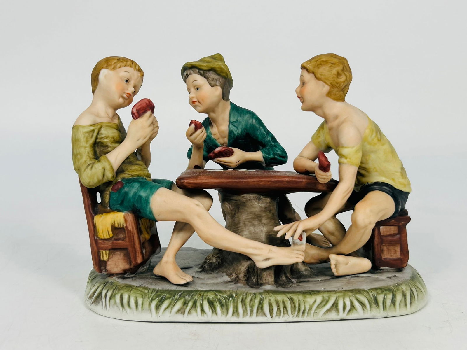 A Reproduction of Pottery Figurine after Italian Capodimonte Porcelain 'The Card Cheats': This is a reproduction of the Italian Capodimonte porcelain 'The Card Cheats', probably originally created by Bruno Merli. 5.3/4 in. high, 8 in. wide.