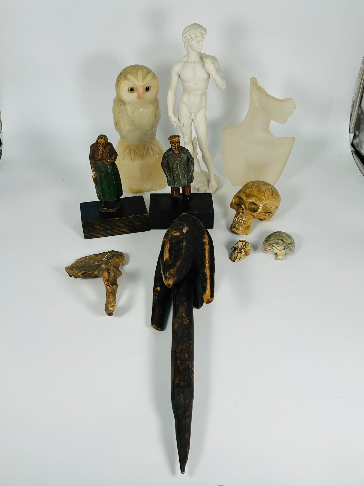 A Group of Ten Decorative Objects: Comprising a hand-carved stone figure of a snowy owl, 9.1/2 in. high, 4.1/2 in. wide; a resin figure of David, 12.3/8 in. high, 4.1/4 in. wide; a pair of vintage carved wood figures, a couple, with wo