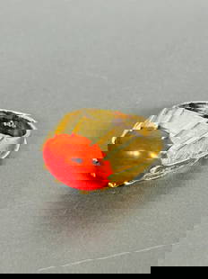 A Coral-Inset 14K Gold Ring: With a '14K' mark to the inner side of the ring, 1 in. long, 3/4 in. wide. Weighs about 7 grams.