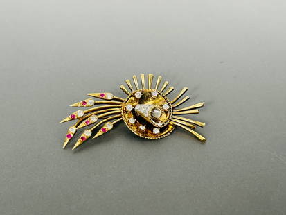 A Vintage Gold, Diamond and Ruby Brooch: 2 in. long, 1.1/8 in. wide.