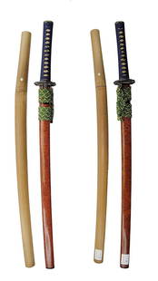 A Japanese Samurai Sword, Katana, Signature Kanemitsu, and Associated Shirasaya: A signature Kanemitsu on one side of tang of the Katana. Mismatching mountings indicates possible later modification. Cutting edge measures 25 in. long, 37.1/4 in. long overall for the Katana; 36.1/2