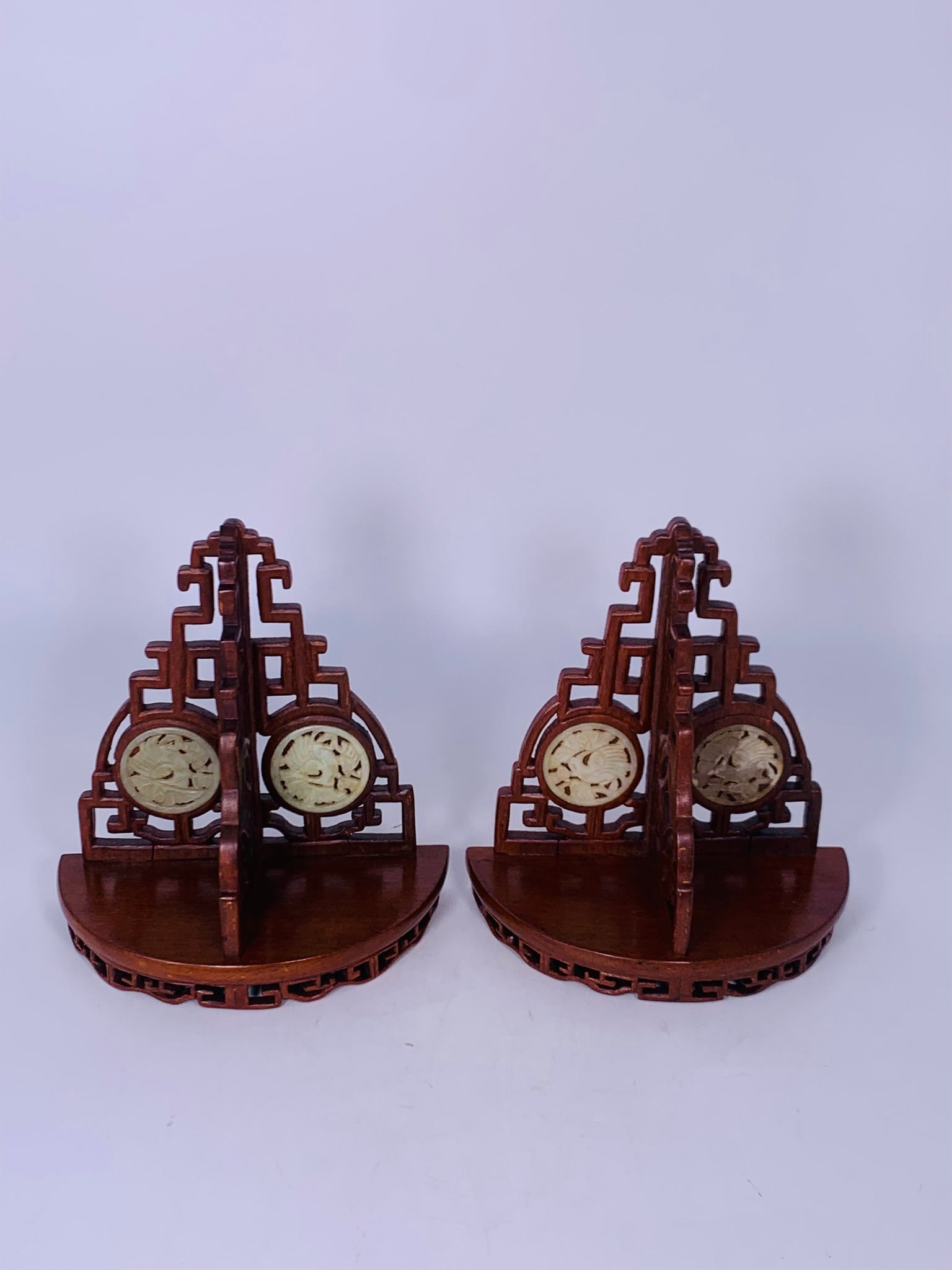 A Pair of Chinese Celadon-Jade-Circular Plaque Inset Wood Racks, 20th Century: 8.5 in. high, 8 in. wide each.