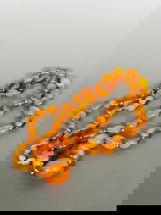 A String of Amber Beads, Necklace: The largest bead measures 1 in. long, 7/8 in. wide; the necklace measures 36 in. long overall. Weight, 79g