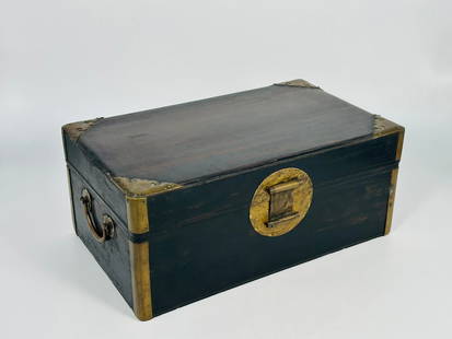 A Chinese Zitan Document Box: The well-proportioned box and cover feature a circular metal lock plate on the front. The rounded edges are reinforced with metal mounts that extend to ruyi-shaped tabs at the four top corners of the