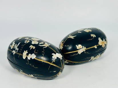 A Pair of Japanese Hand Carved 'Mother-of-Pearl'-Inlaid Melon Form Black Lacquered Boxes and Covers: A pair of Vintage hand-carved box in the shape of a melon, featuring mother-of-pearl floral inlays accented with gilt striping and scrollwork. The interior is finished in black lacquer. 3.1/2 in. high