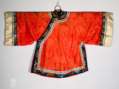 A Chinese Embroidered Red Silk Lady's Informal Jacket: 40 in. high, 57 in. wide.