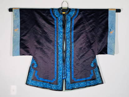 A Chinese Embroidered Navy-Blue Silk Lady's Informal Jacket: 42 in. high, 50 in. wide.