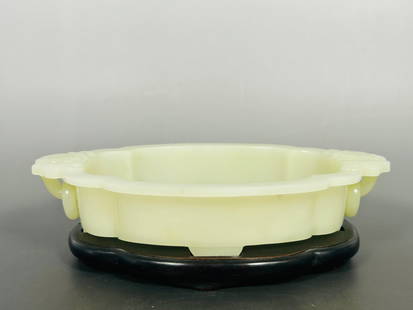 A Chinese Greenish Jade Water Pot: With a wood stand. The pot measures 1.3/4 in. high, 9.1/8 in. wide for the pot.