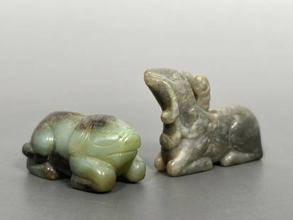Two Chinese Jade Carving of Animals: Comprising a celadon and russet jade carving of a pig, perhaps as a pendant, 7/8 in. high, 1.3/4 in. wide; and a jade carving of a goat, 1.1/2 in. high, 1.7/8 in. wide.