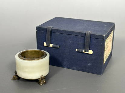 A Chinese White Jade and Brass Tripod Water Pot: 1.3/8 in. high, 2.1/8 in. wide. Cloth box.