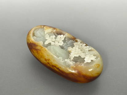 A Chinese Carved Celadon and Russet Jade 'Landscape' Boulder: 3.1/4 in. high, 1.3/4 in. wide.